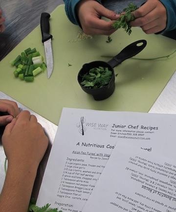 Wise Way Junior Chef Recipes — children chopping fresh herbs with recipe card